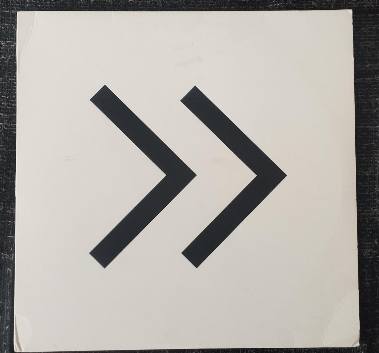 Pochette de disque comportant deux chevrons noirs sur fond blanc.