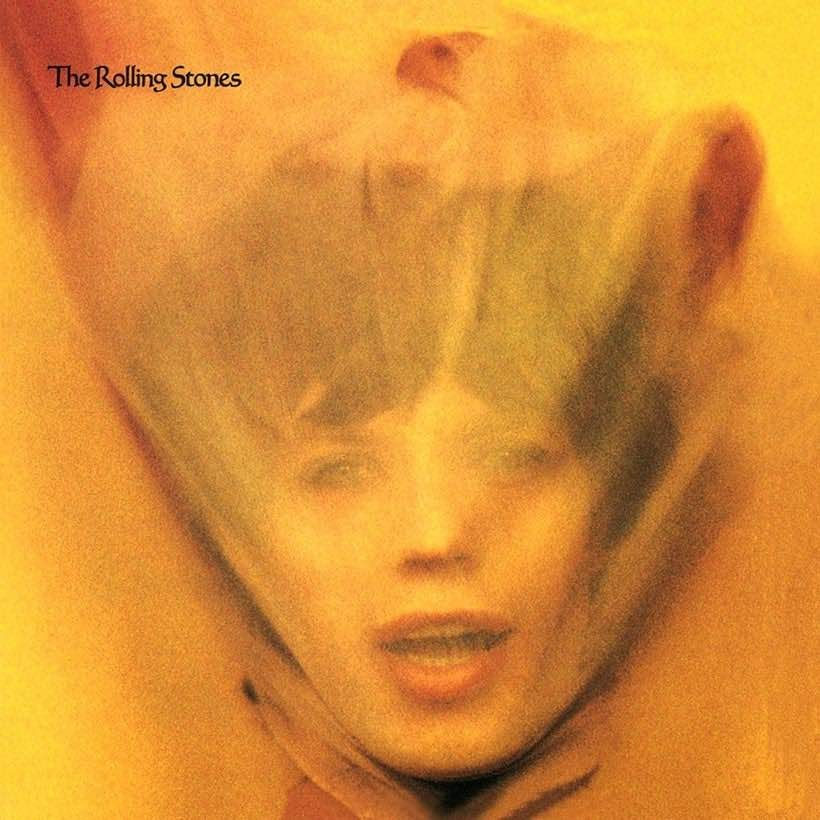 A yellow portrait of Mick Jagger, a cloth pulled over his face and dragged to the top, making his face surrounded with some kind of flames.