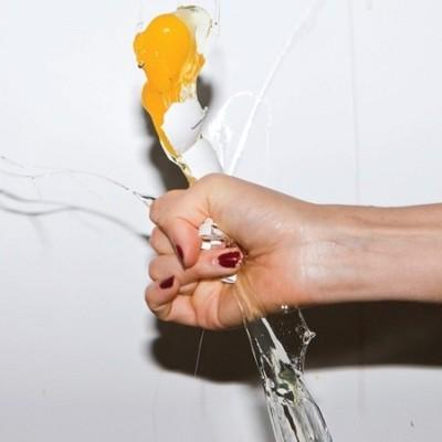 Album cover of Yeah Yeah Yeahs - It's blitz! A woman hand squashing a fresh egg