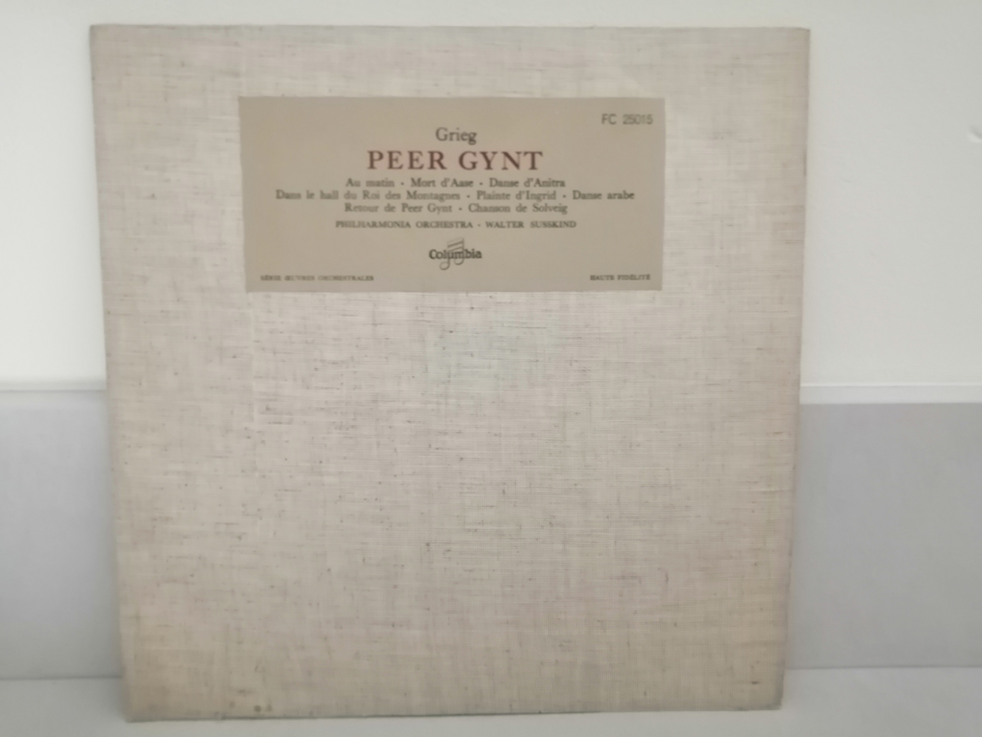 Une pochette de disque en tissus beige avec une étiquette "Grieg Peer Gynt".